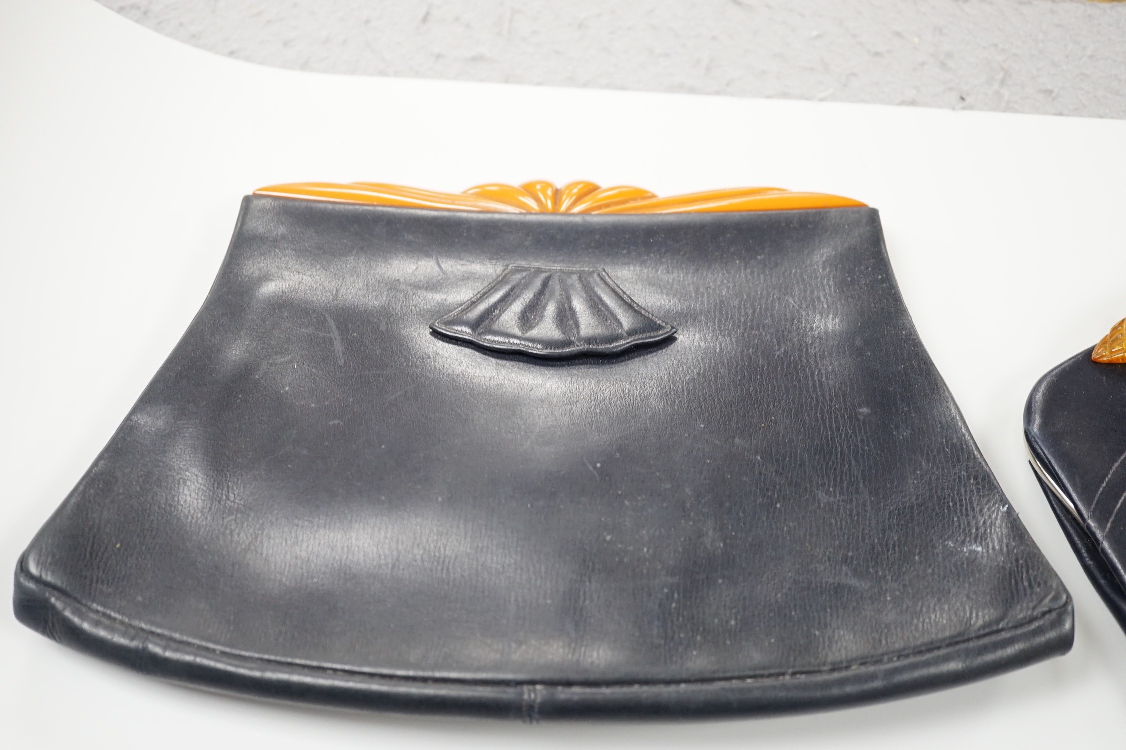 A 1930's Pierrot bakelite bag frame, together with three 1930's yellow bakelite and leather clutch bags (4)